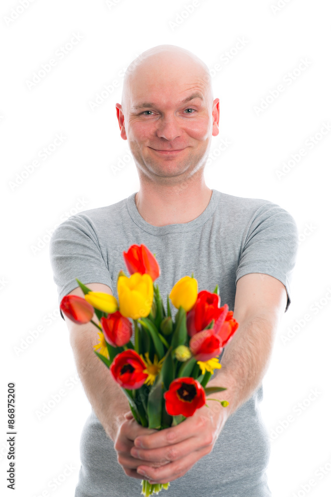 young man with bald head and bunch of tulips young man with bald head and bunch of tulips