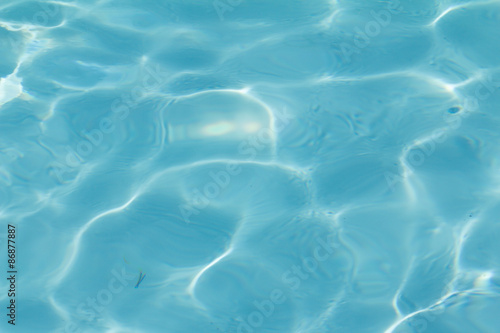 Fototapeta Naklejka Na Ścianę i Meble -  Blue pool water with sun reflections