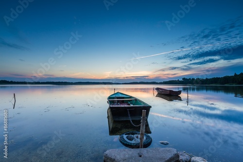 Fototapeta Naklejka Na Ścianę i Meble -  Beautiful lake sunset with fisherman boats