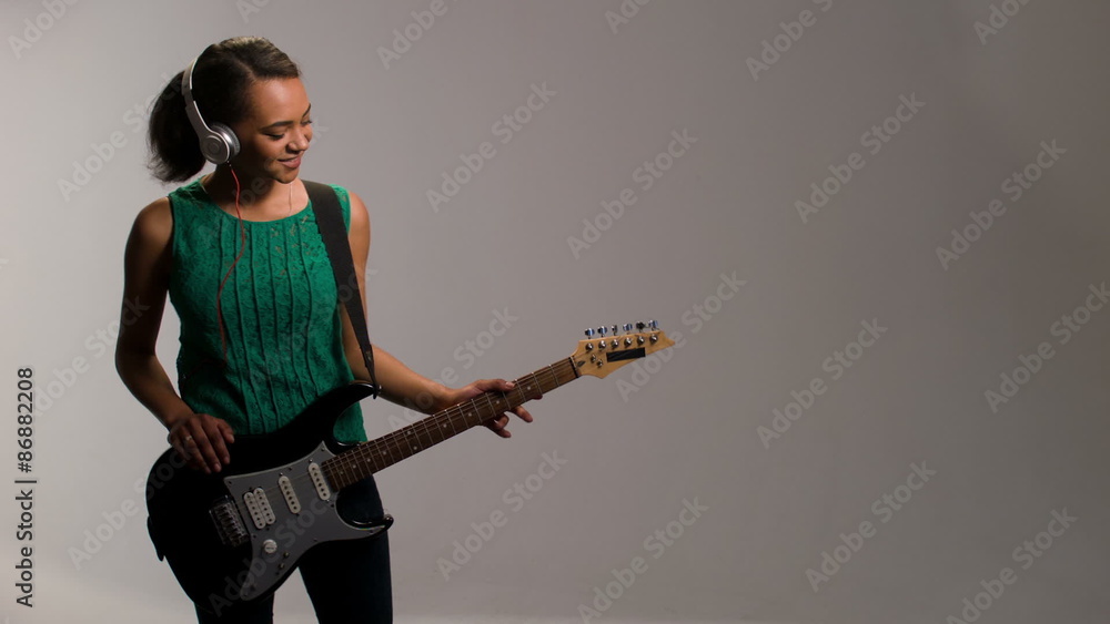 lovely woman plays on guitar and listens to music