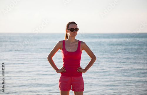 Smiling woman standing on the seacoast