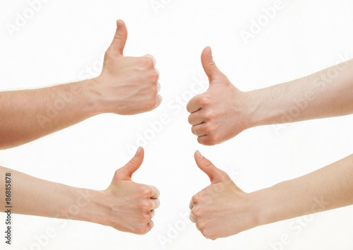 Four hands showing thumb up signs