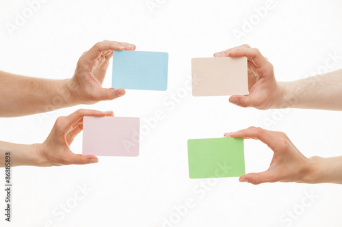 Human hands holding colorful paper cards