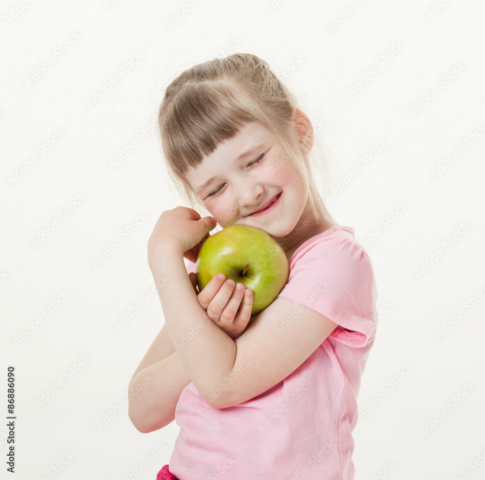 Happy little girl holding a green apple Happy little girl holding a green apple