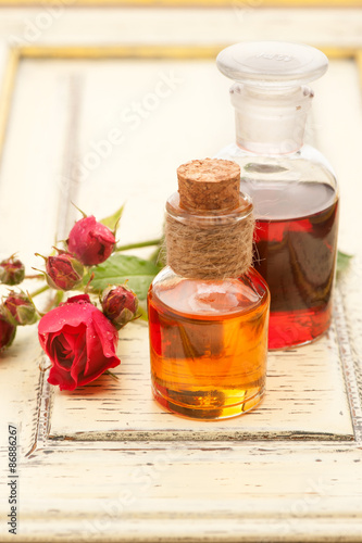 Rose essential oil and rose flowers. Spa, body care and aromatherapy.