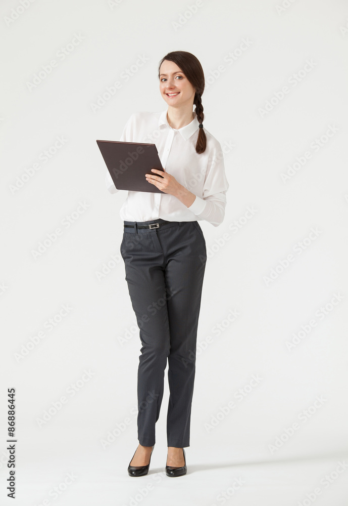 Smiling young businesswoman holding clipboard Smiling young businesswoman holding clipboard