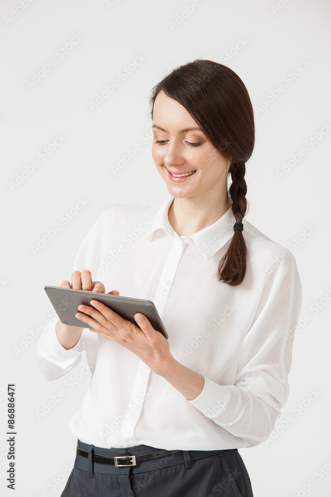 Smiling young businesswoman holding a pad and showing thumb up s Smiling young businesswoman holding a pad and showing thumb up s