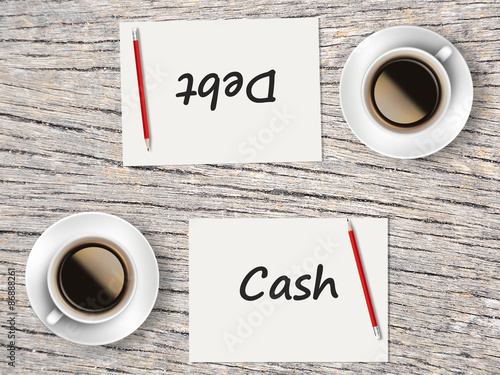 Business Concept : Comparison between cash and debt