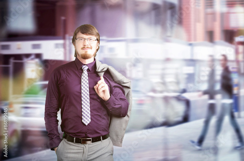 Portrait of a young businessman holding jacket over his shoulder