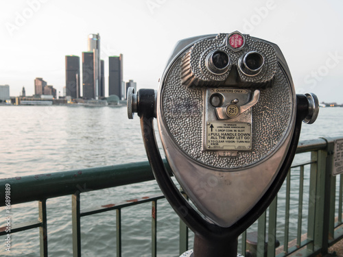 Detroit Sightseeing from Windsor. Sightseeing tourist binoculars overlooking downtown Detroit, Michigan on a summer afternoon from Windsor, Ontario, Canada.