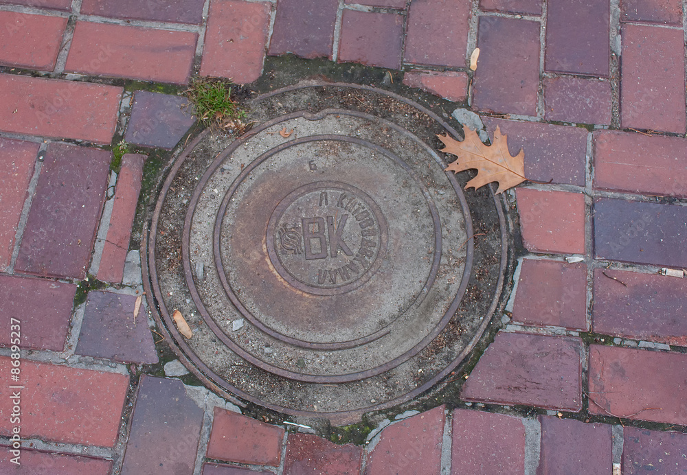 Kiev, Ukraine - October 22, 2013: Manhole and pavement in the ce