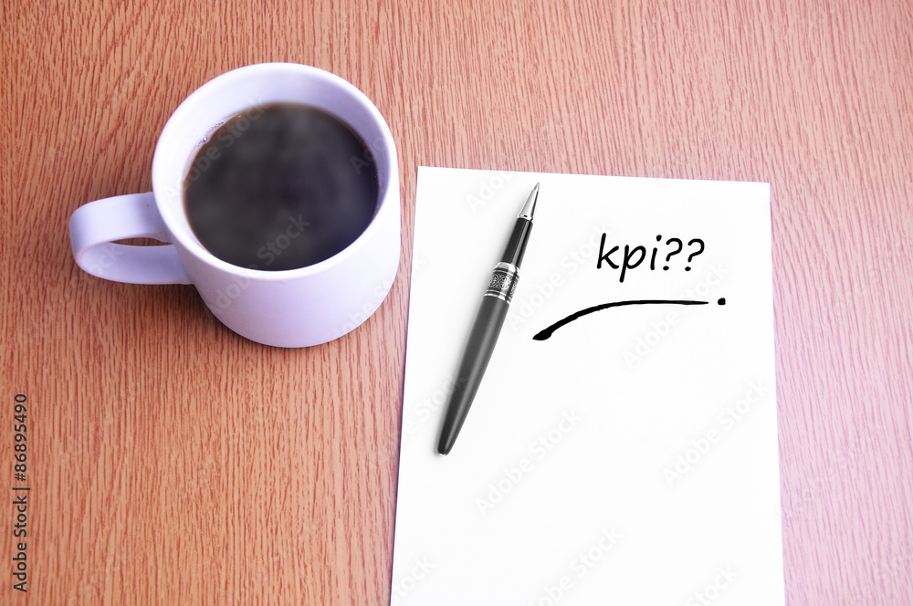 Coffee, pen and notes write kpi Coffee, pen and notes write kpi