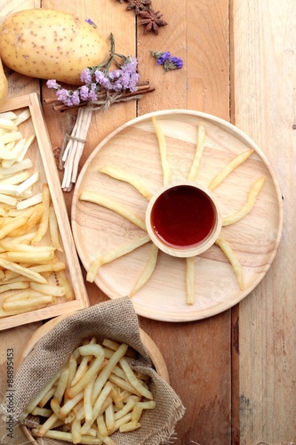 French fries and fresh sliced potatoes with ketchup.