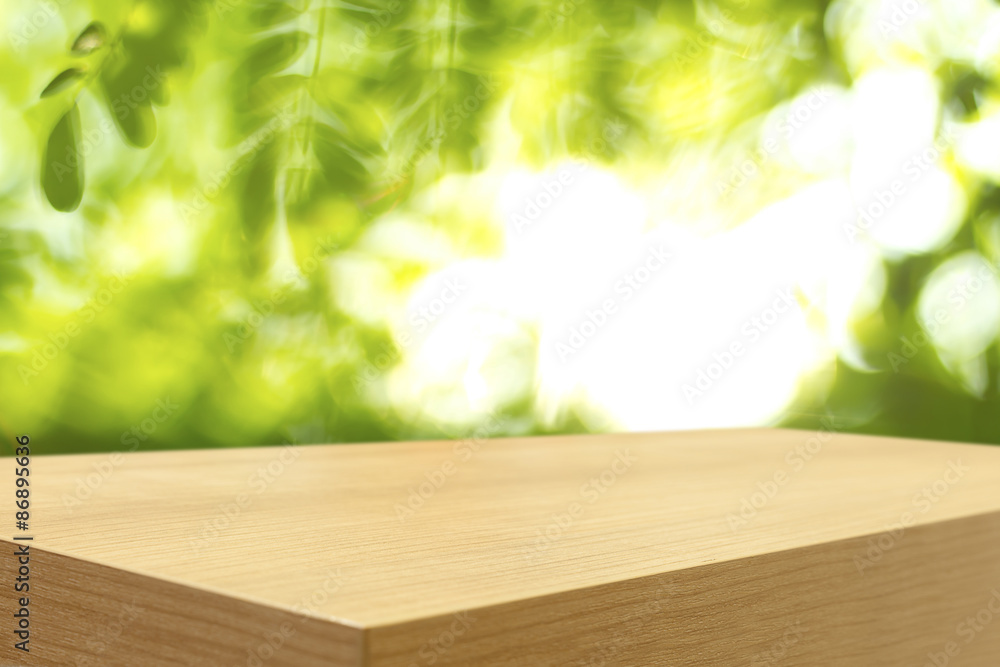 Empty wooden table and green natural spring blur bokeh backgroun Empty wooden table and green natural spring blur bokeh backgroun