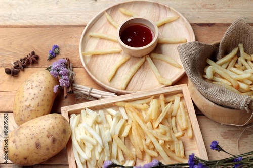 Fototapeta Naklejka Na Ścianę i Meble -  French fries and fresh sliced potatoes with ketchup.