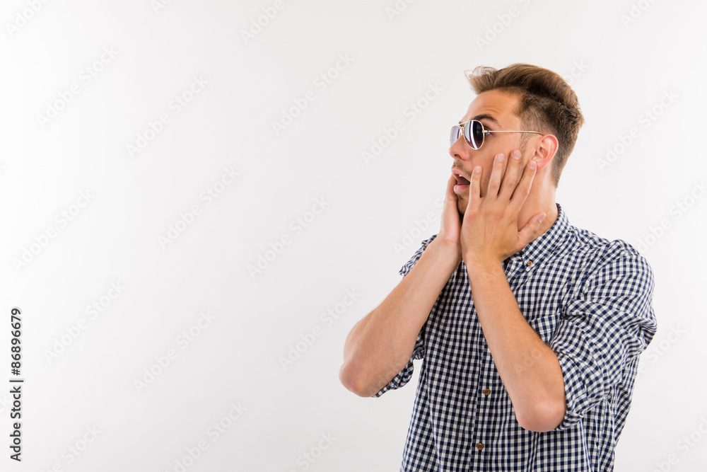 Surprised handsome young man looking away