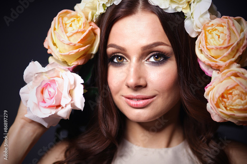 Portrait of a beautiful woman with flowers in her hair. Fashion