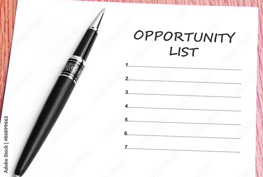 Pen and notes paper with opportunity list Pen and notes paper with opportunity list