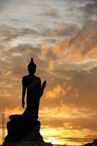 Big Buddha statue on sunset sky.