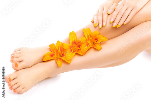 pedicure and manicure with a orange lily flower