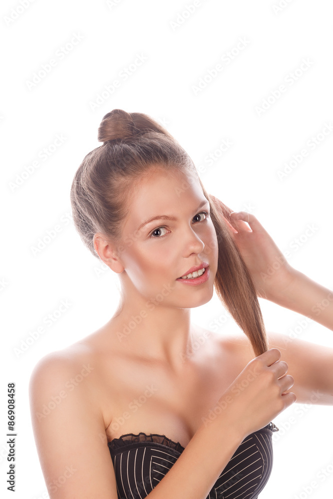 Teen Girl with nude makeup stroking her hair. Teen Girl with nude makeup stroking her hair.