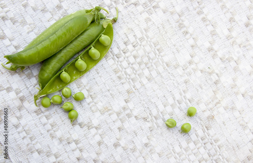 Green peas on the vintage linen background