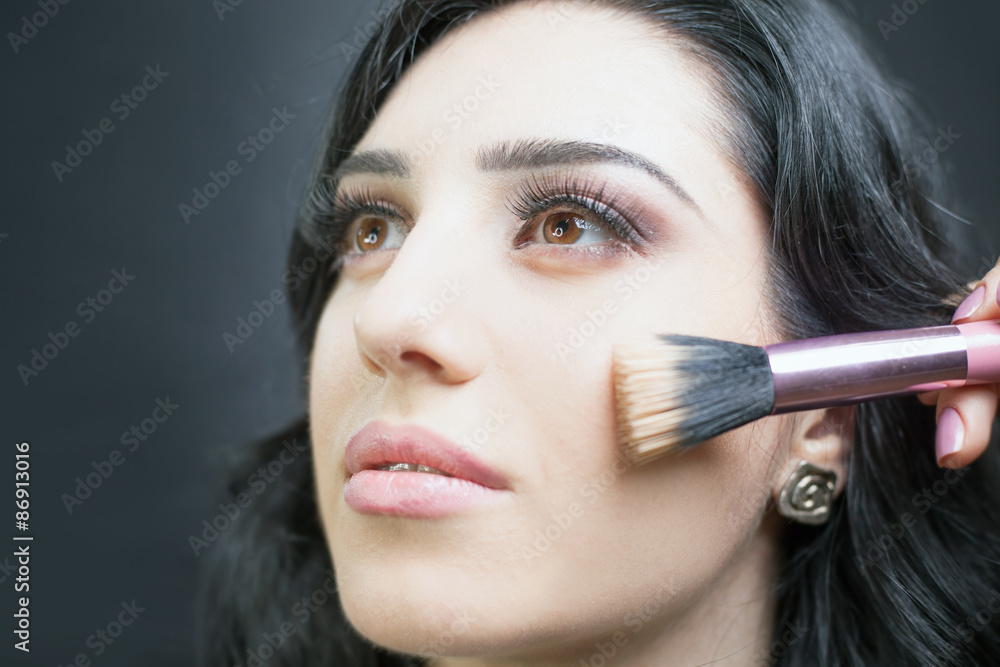 Beautiful woman at beauty salon receives makeup Beautiful woman at beauty salon receives makeup