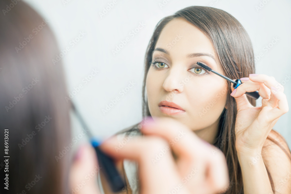 makeup artist woman doing make-up using cosmetic brush for yourself makeup artist woman doing make-up using cosmetic brush for yourself