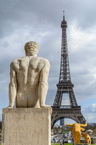 statue of a man looking at the eiffel tower at trocadero square in Paris, France