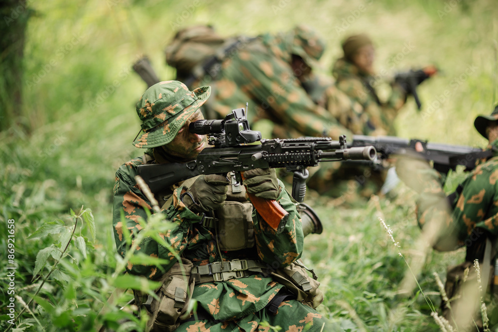Group of soldiers special forces during the raid in the forest Group of soldiers special forces during the raid in the forest