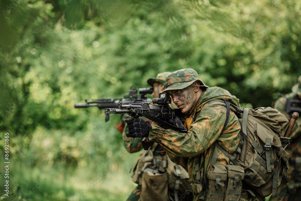 Group of soldiers special forces during the raid in the forest Group of soldiers special forces during the raid in the forest