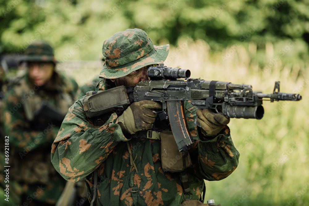 Group of soldiers special forces during the raid in the forest Group of soldiers special forces during the raid in the forest