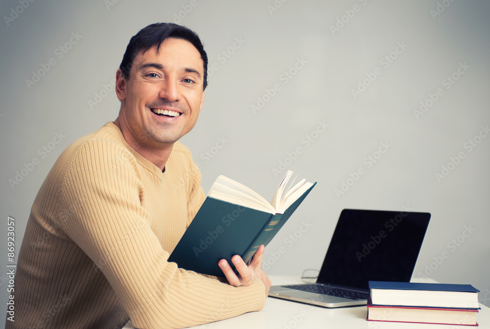 handsome young man reading a book handsome young man reading a book