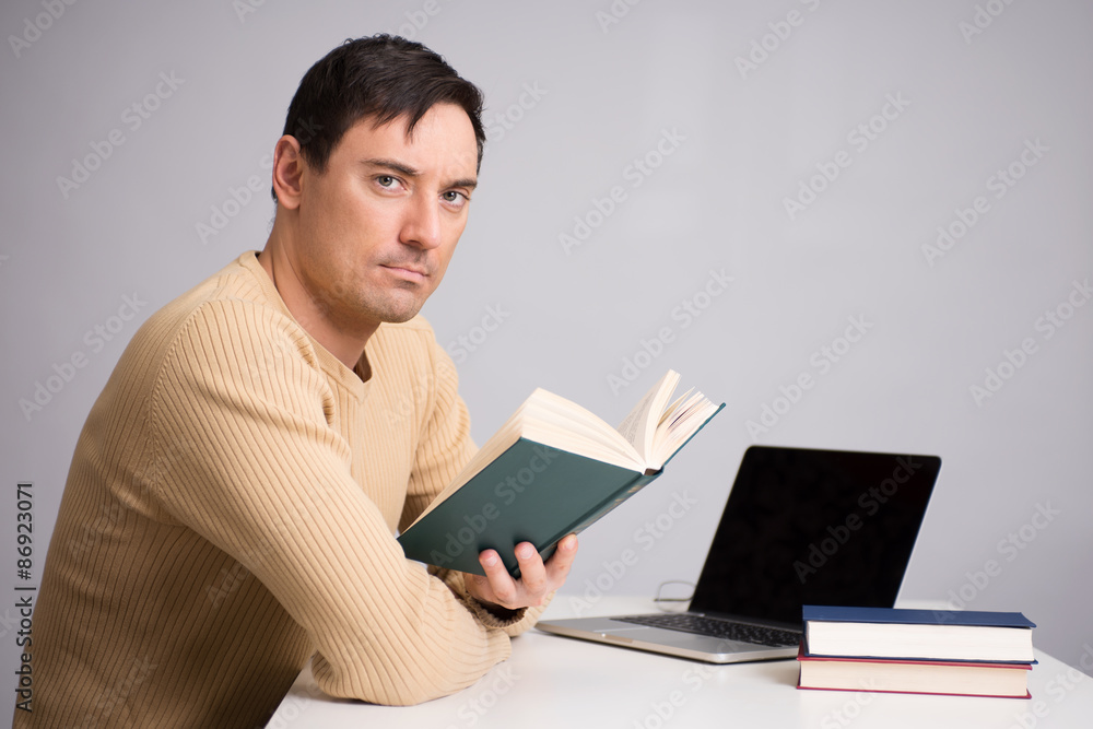 handsome young man reading a book handsome young man reading a book