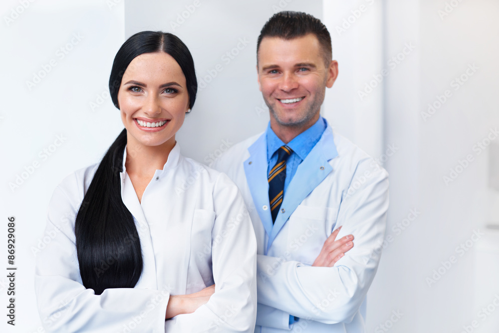 Dentist Team at Dental Clinic. Two Smiling Doctors at their Work Dentist Team at Dental Clinic. Two Smiling Doctors at their Work