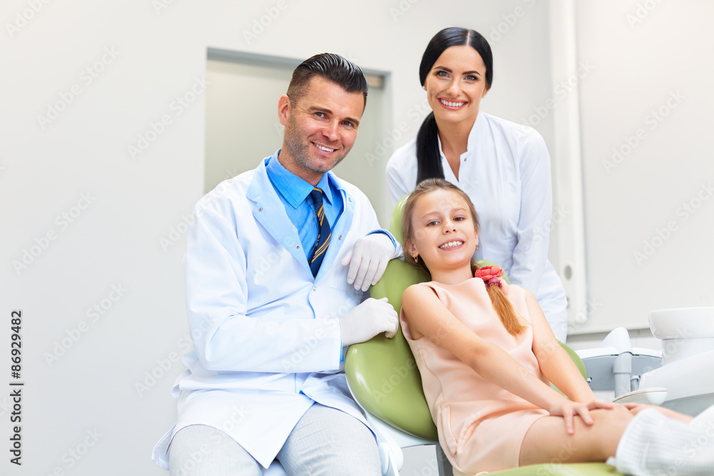 Obraz premium Dentist Team and Happy Patient at Dental Clinic