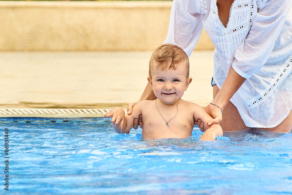 Mother holding child in the pool