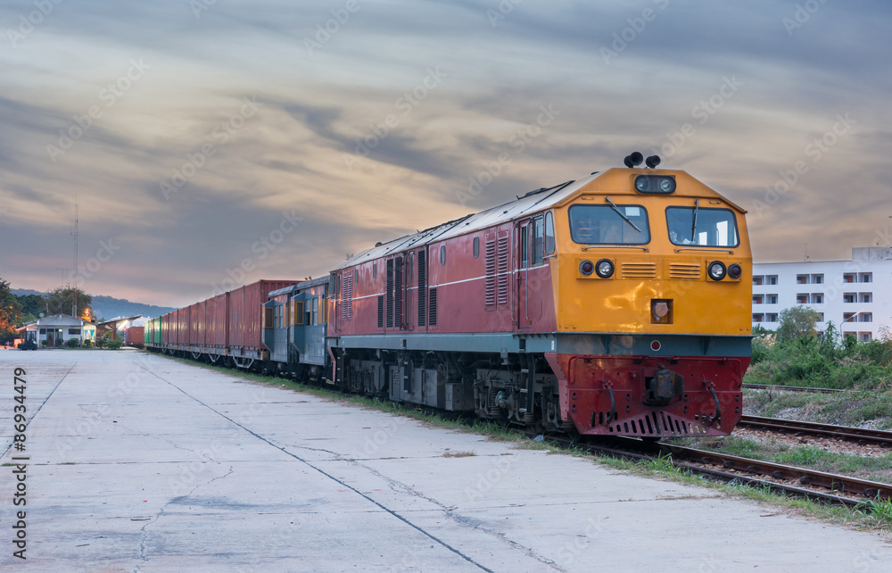 Fototapeta premium Cargo train and container at twilight