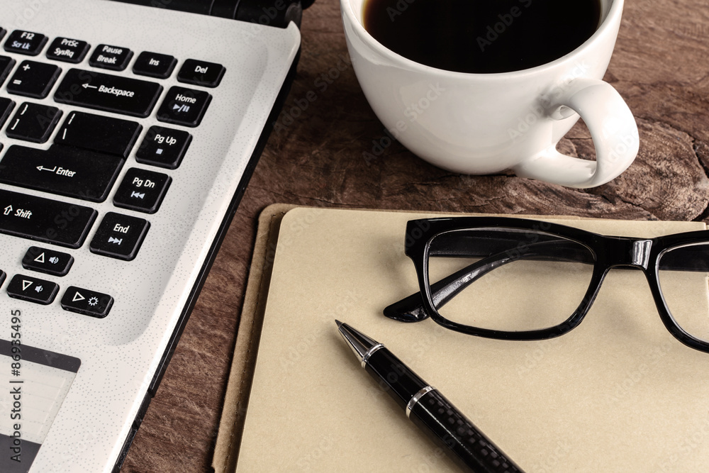 Laptop and cup of coffee on old wooden table Laptop and cup of coffee on old wooden table