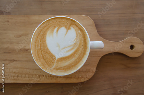 cappuccino over wooden table