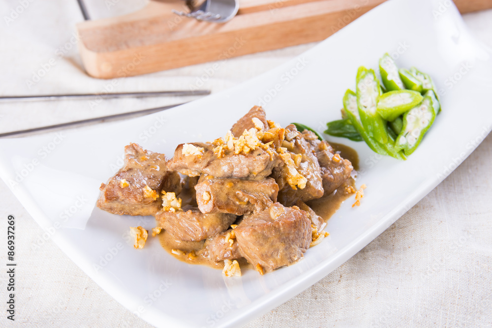 beef salpicao, or beef with creamy soy sauce topped with toasted garlic beef salpicao, or beef with creamy soy sauce topped with toasted garlic