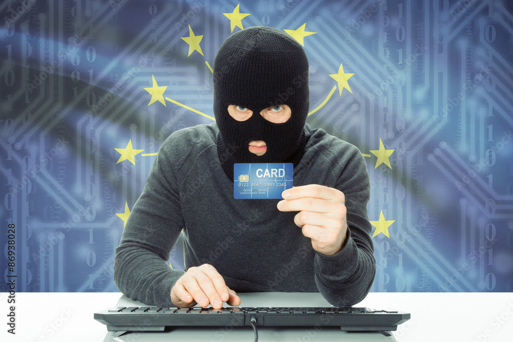 Hacker holding credit card and USA state flag on background - Indiana Hacker holding credit card and USA state flag on background - Indiana