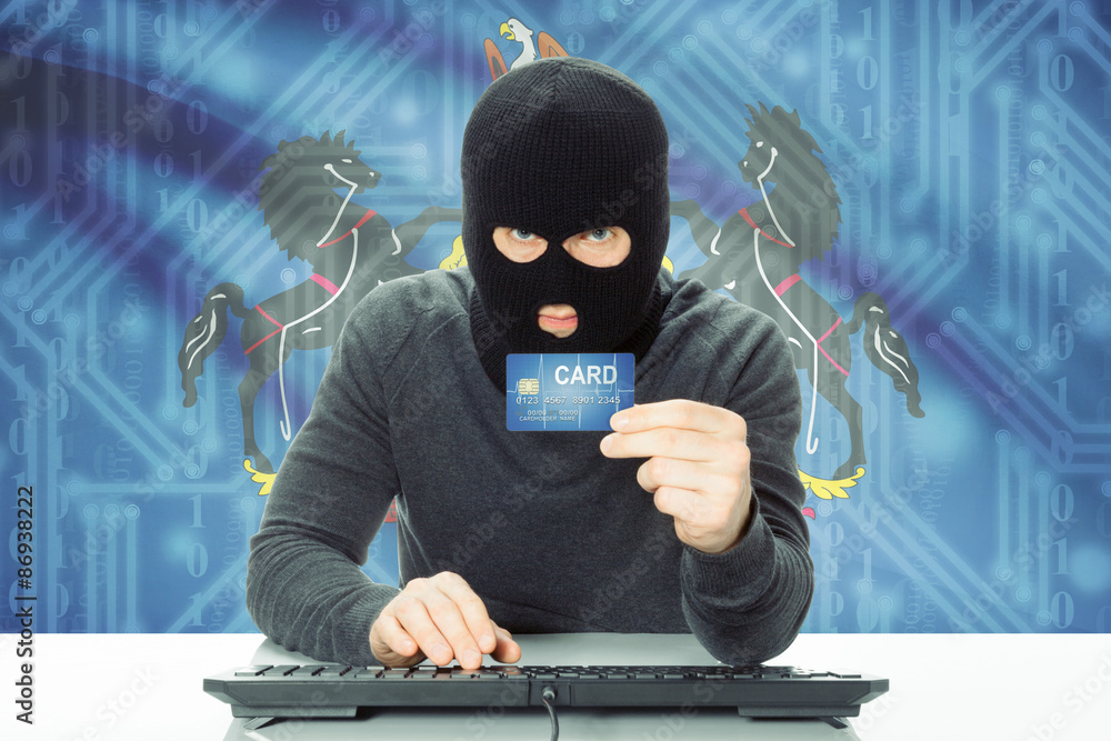 Hacker holding credit card and USA state flag on background - Pennsylvania Hacker holding credit card and USA state flag on background - Pennsylvania