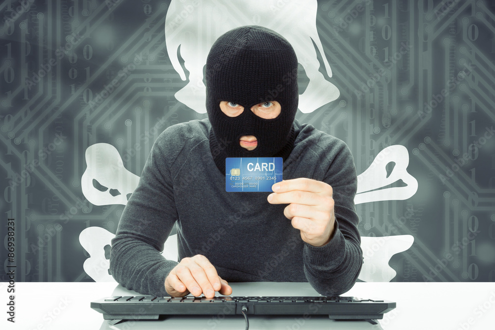 Hacker holding credit card and flag on background - Jolly Roger Hacker holding credit card and flag on background - Jolly Roger