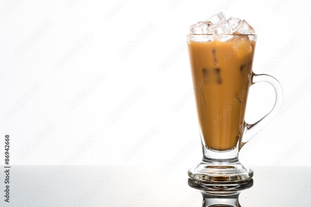 Refreshing ice cold coffee with milk in transparent glass flushed right Refreshing ice cold coffee with milk in transparent glass flushed right