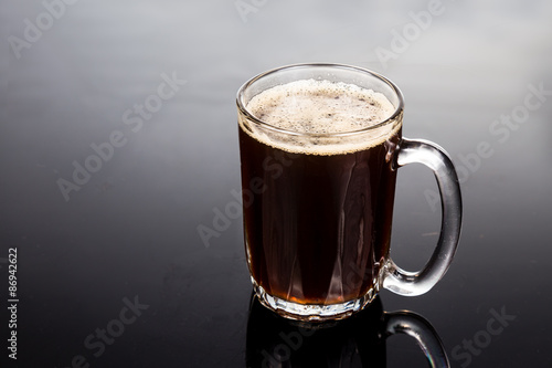 Aromatic hot black coffee in a transparent glass