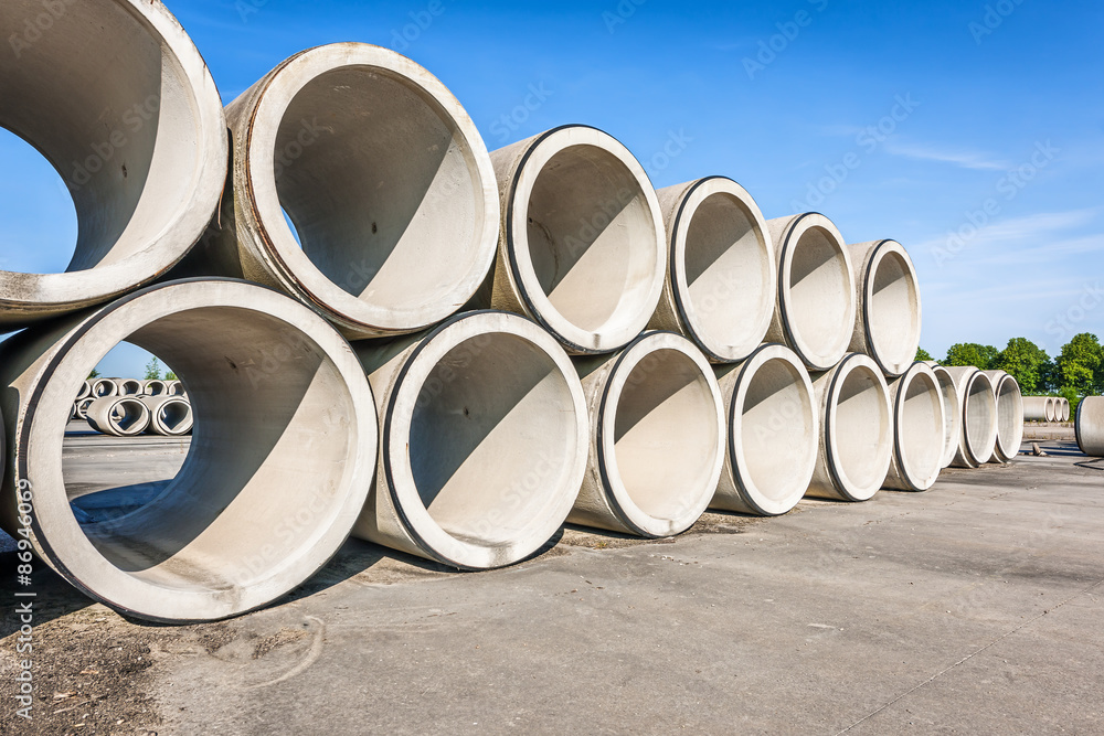 Big concrete sewage pipes stored in a factory Big concrete sewage pipes stored in a factory