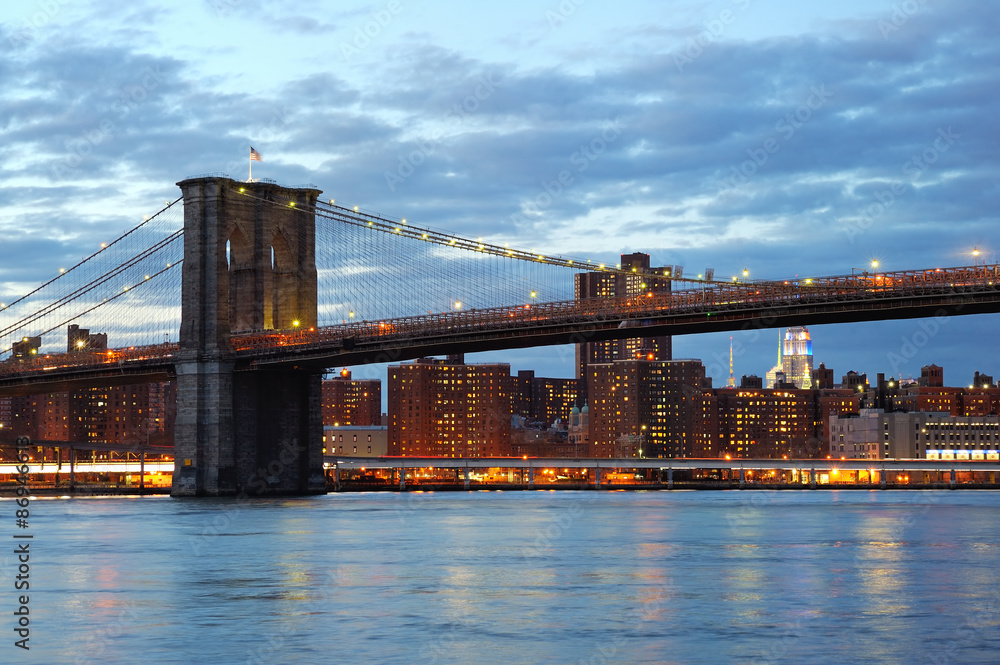 Brooklyn Bridge with downtown skyline at dusk
