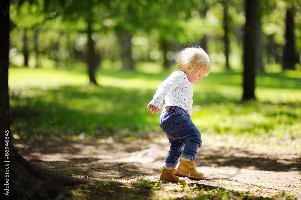 Toddler boy walking in the park Toddler boy walking in the park