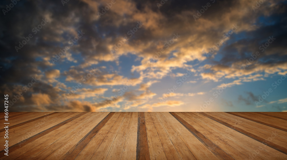 Stunning colorful Winter sunset sky with wooden planks floor